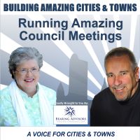 Flyer titled "Running Amazing Council Meetings" featuring a woman on the left and a man on the right with the text "Building Amazing Cities & Towns" at the top. Logo of Bearing Advisors at the bottom.